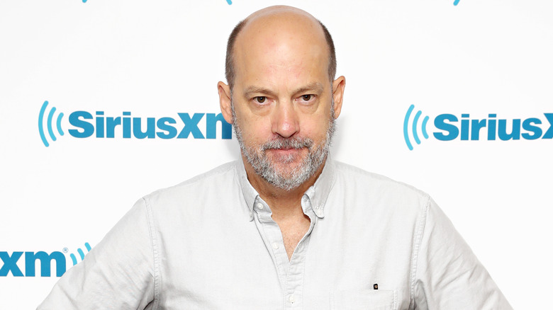 Anthony Edwards with a beard in a white shirt