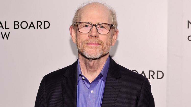 Ron Howard in black jacket and purple shirt