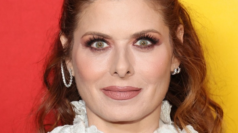 Debra Messing in a white dress at Bros premiere