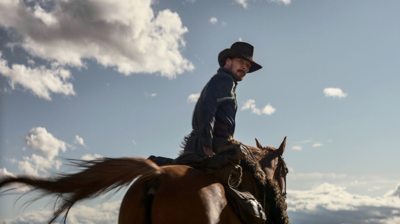 Benedict Cumberbatch riding a horse in The Power of the Dog