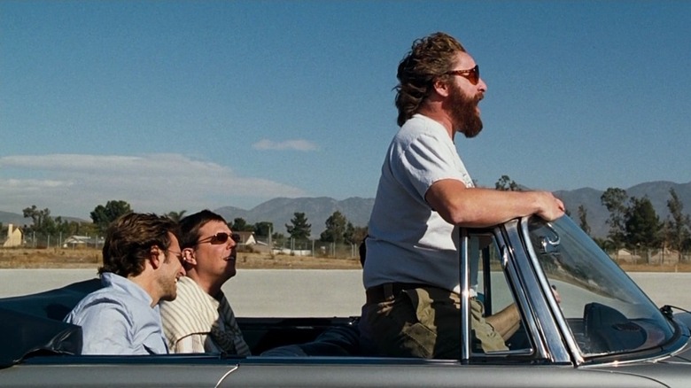 Three men riding in an open-top convertible in The Hangover