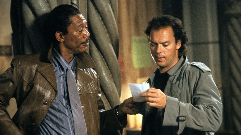 Morgan Freeman looks at Kevin Costner holding note