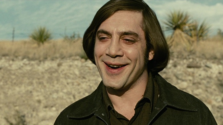 Anton Chigurh grinning menacingly