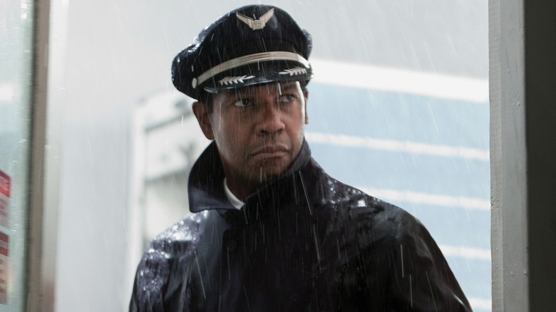 Captain Whitaker standing in doorway while it rains outside