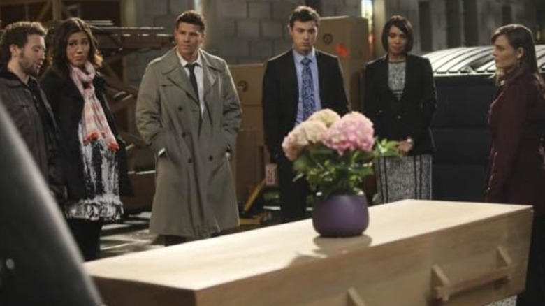 The Jeffersonian team surrounding a casket