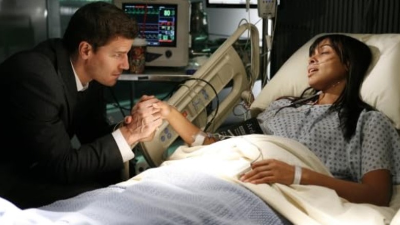 Booth holds Cam's hand in the hospital