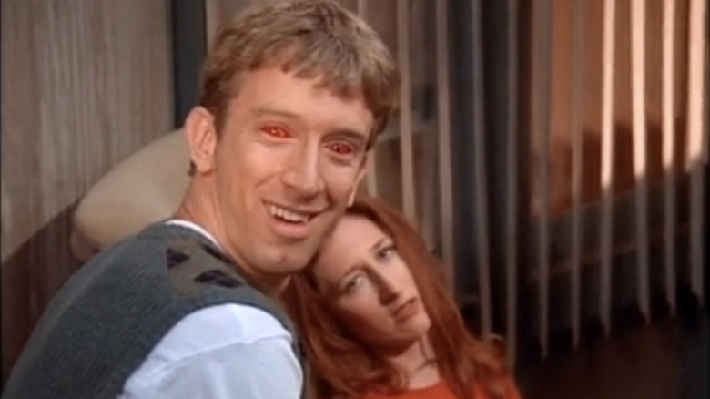 Andy Dick with red eyes and Vicki Lewis on "NewsRadio"