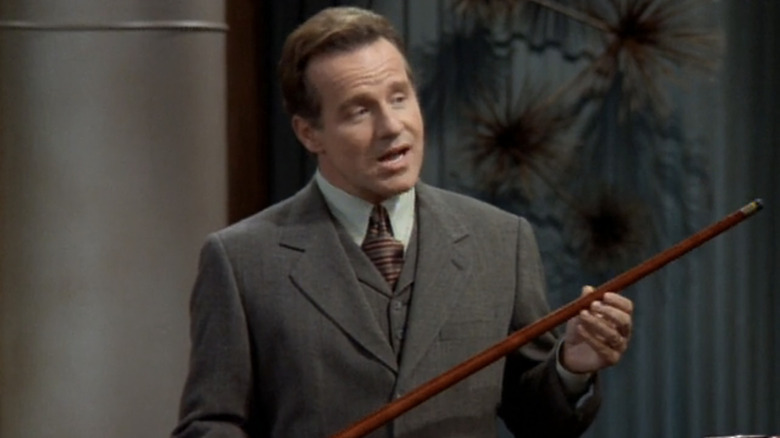 Phil Hartman holding a cane on "NewsRadio"