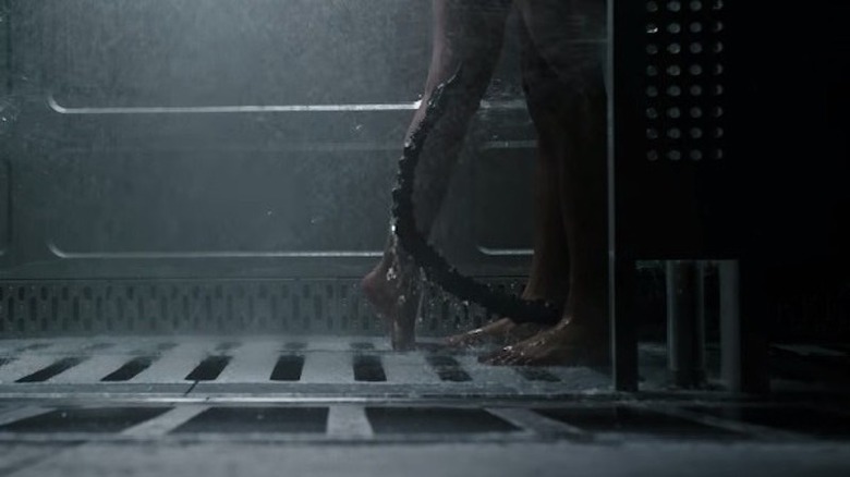 Alien tail between Ricks and Upworth's legs in shower