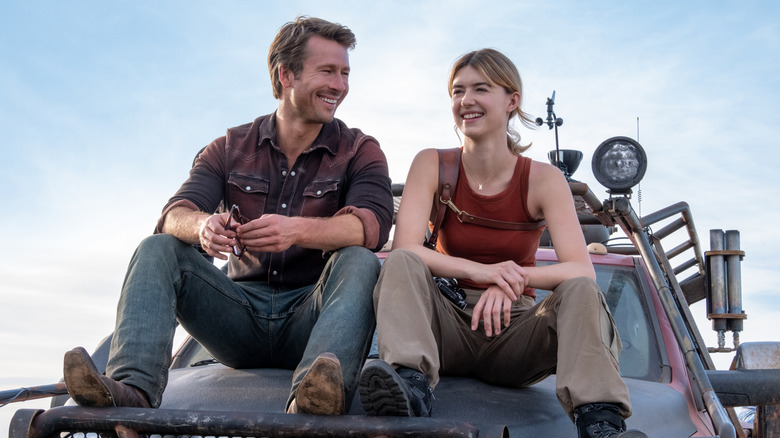 Kate and Tyler sitting on truck hood laughing in Twisters (2024)