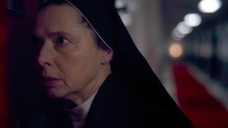 Sister Agnes listens at a door in "Conclave" (2024)