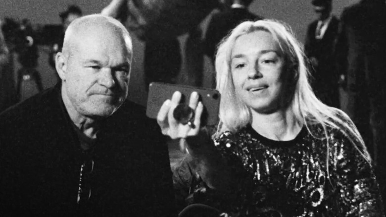 Uwe Boll and Angela shooting a TikTok in "Don't Expect Much from the End of the World" (2024)