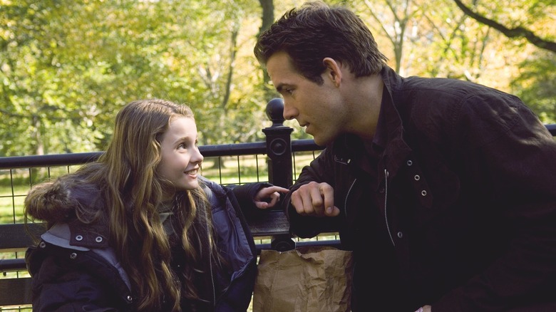 Will looks at Maya on park bench