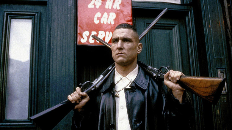 Big Chris holds two shotguns in "Lock, Stock and Two Smoking Barrels" (1998)