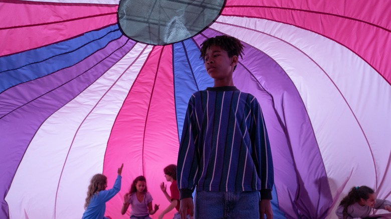 young Owen stands under a parachute in "I Saw the TV Glow" (2024)