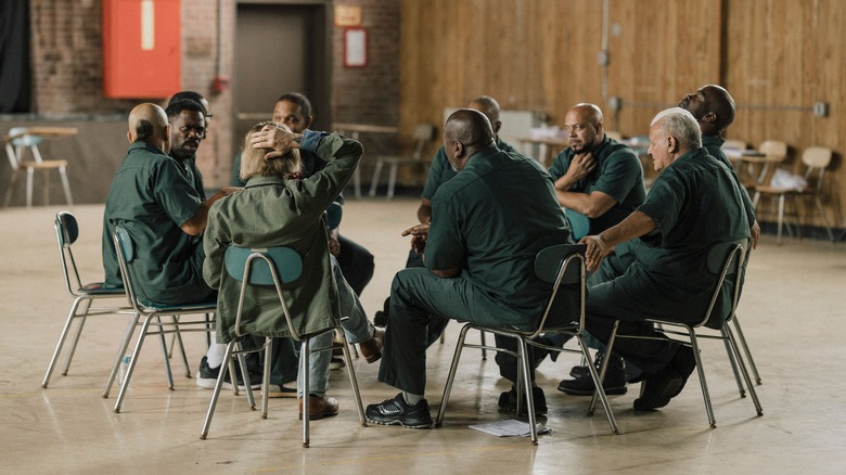 the theatre group sits in a circle in "Sing Sing" (2023)