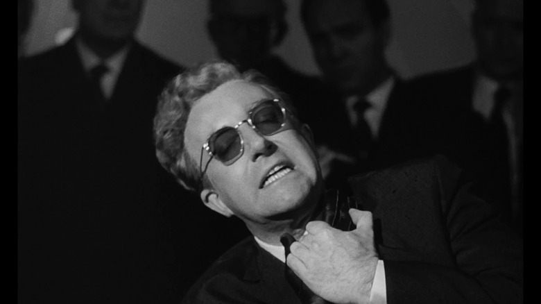 Dr. Strangelove clasps his hands