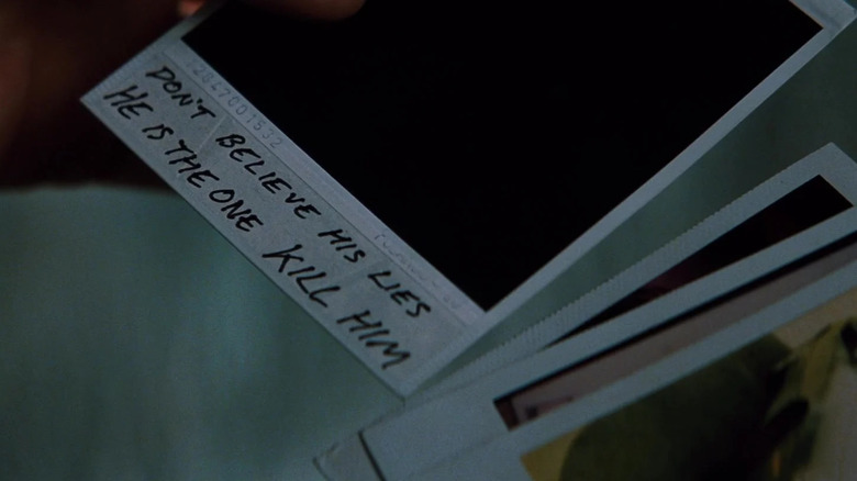 A note on a Polaroid reads "Don't believe his lies, he is the one, kill him" in "Memento" (2000)