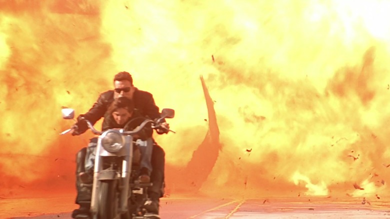 The T-800 and John Connor ride a motorcycle from an explosion in "Terminator 2: Judgment Day" (1991)