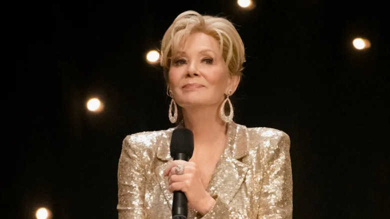 Deborah Vance onstage with a microphone in hand