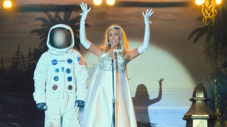 Maxine performs next to an astronaut in "Palm Royale"