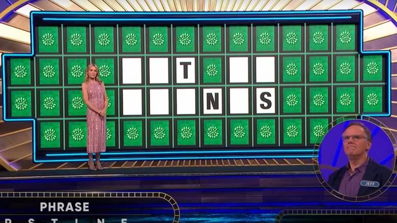 Vanna White standing in front of Wheel of Fortune board