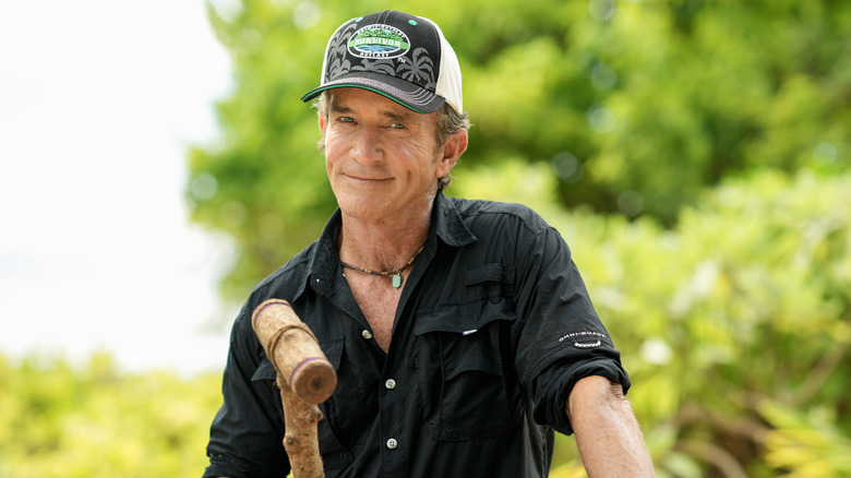 Jeff Probst smiling and wearing a Survivor cap