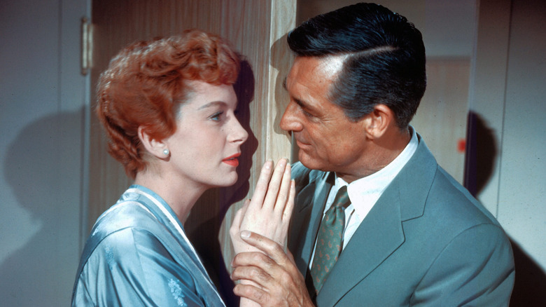 Cary Grant holding Deborah Kerr's hand