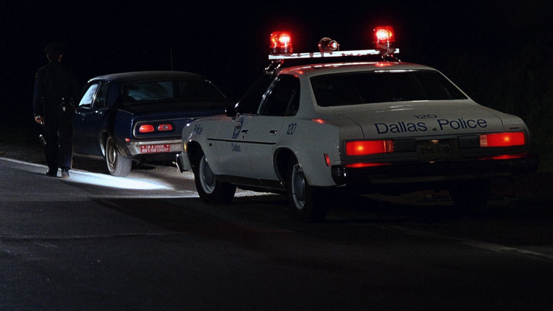 A police car pulling over a blue car