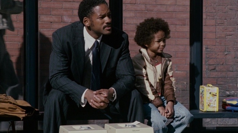 Chris and his son sitting at bus stop