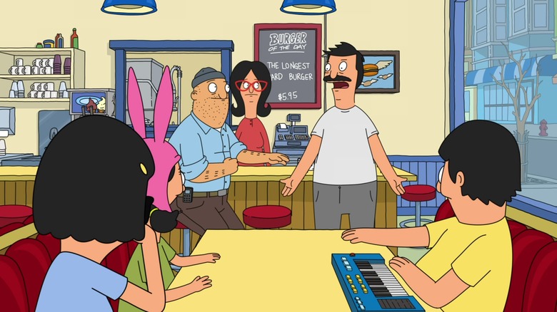 Bob talks to his family and Teddy inside the Bob's Burgers restaurant