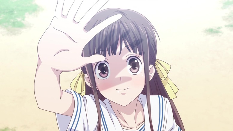 Tohru reaches her hand towards the sky, casting a shadow on her face