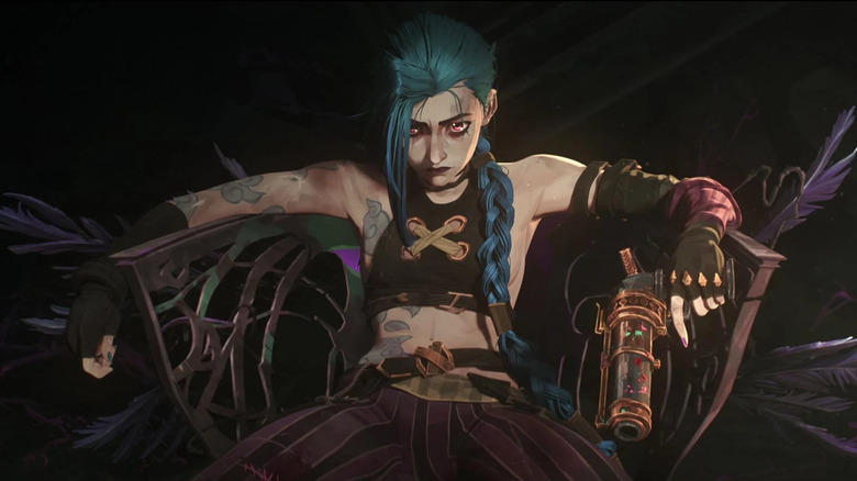 Jinx leans back in a chair holding a gun