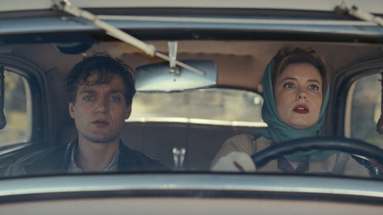 Mary and Varian driving a vintage car