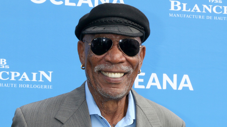 Morgan Freeman smiling in a hat and sunglasses