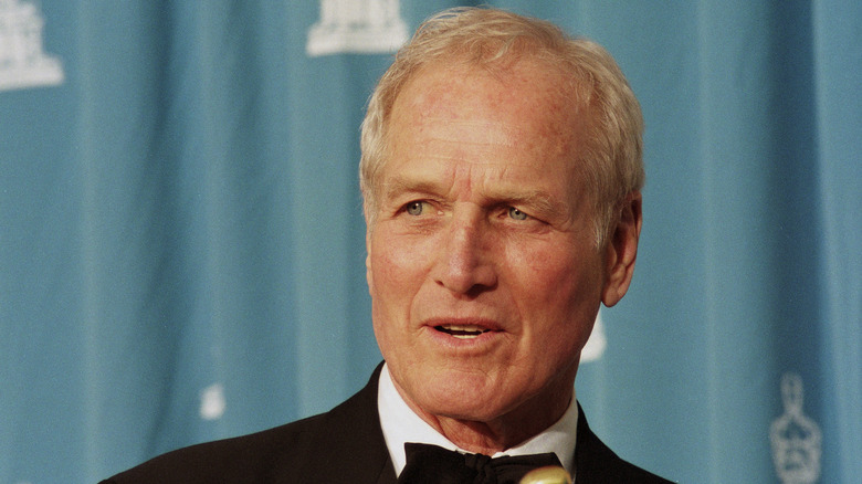 Paul Newman smiling for a photo at the Academy Awards