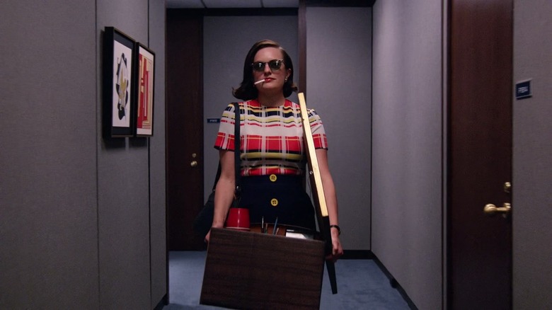 Peggy walks down the hallways of the McCann offices