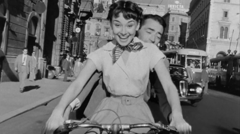 Audrey Hepburn smiling on a Vespa