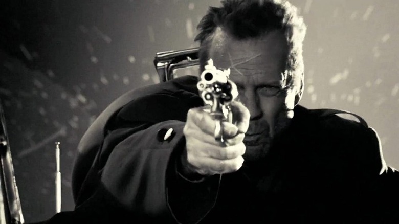 Bruce Willis aims gun