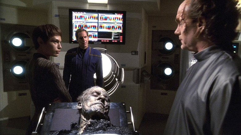 T'Pol, Archer, and Phlox examine a body