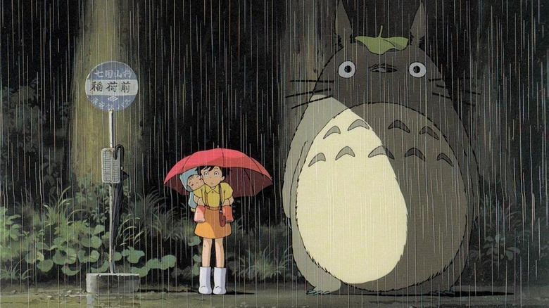 Totoro stands in rain with Satsuki and Mei