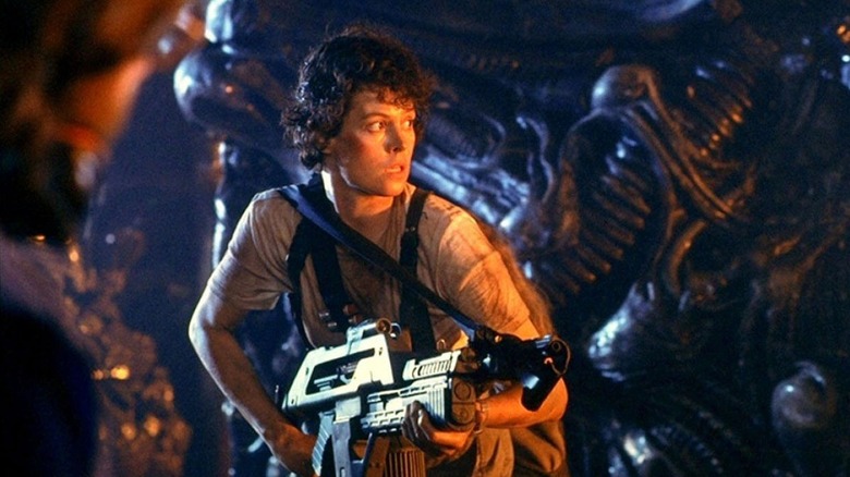 Ripley holds a rifle