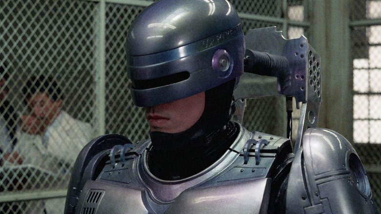 Robocop looks ahead in a fenced area