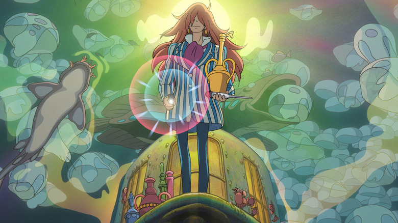 Fujimoto shines light, holding a potion, surrounded by sea creatures