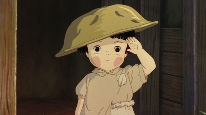 Setsuko salutes wearing a bowl for a hat