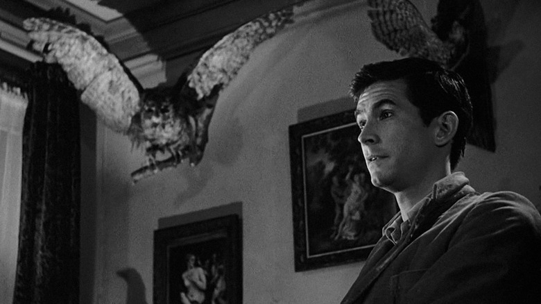 Norman Bates next to taxidermied owl