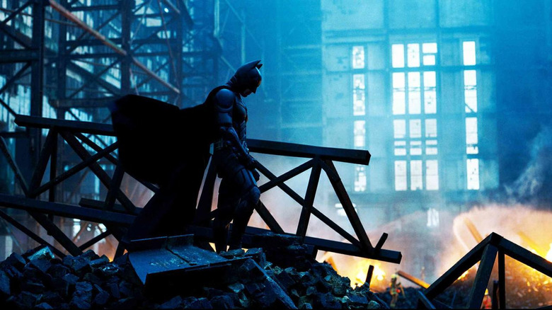 Batman standing in rubble