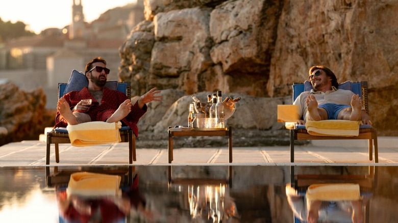 Cage and Pascal enjoy drinks poolside