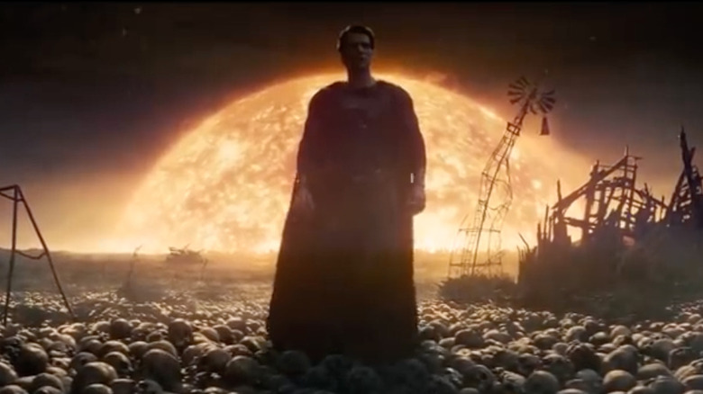 Henry Cavill as Superman in "Man of Steel," standing atop skulls