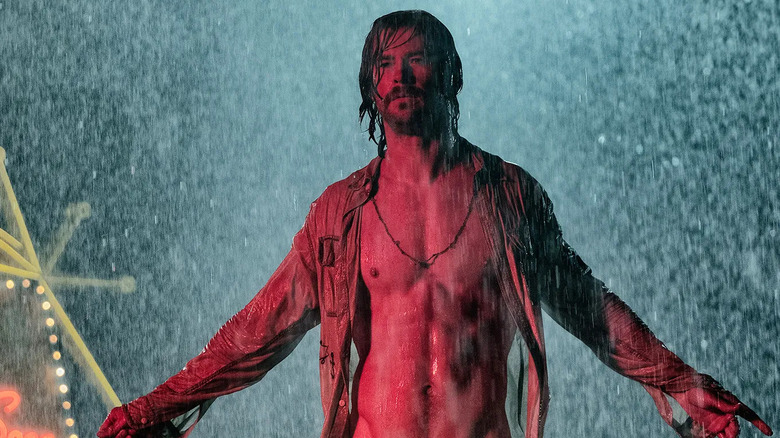 Billy Lee shirtless in the rain